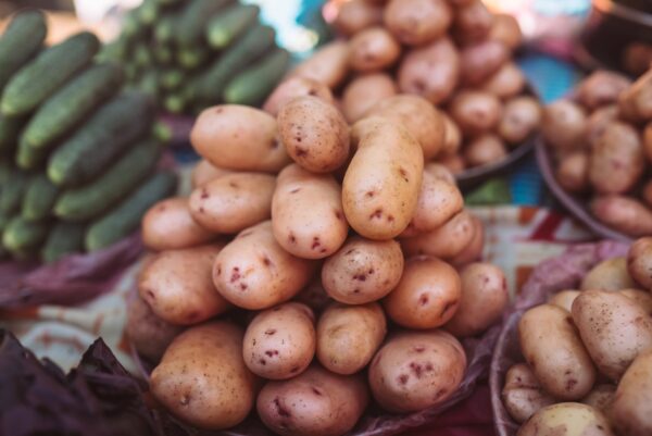 Closeup of potatoes on counter of farm market for sale.