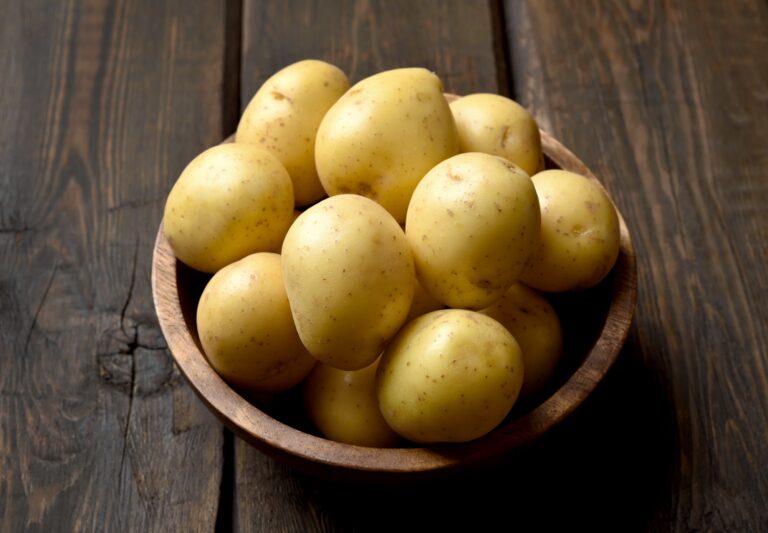 Raw potatoes in bowl